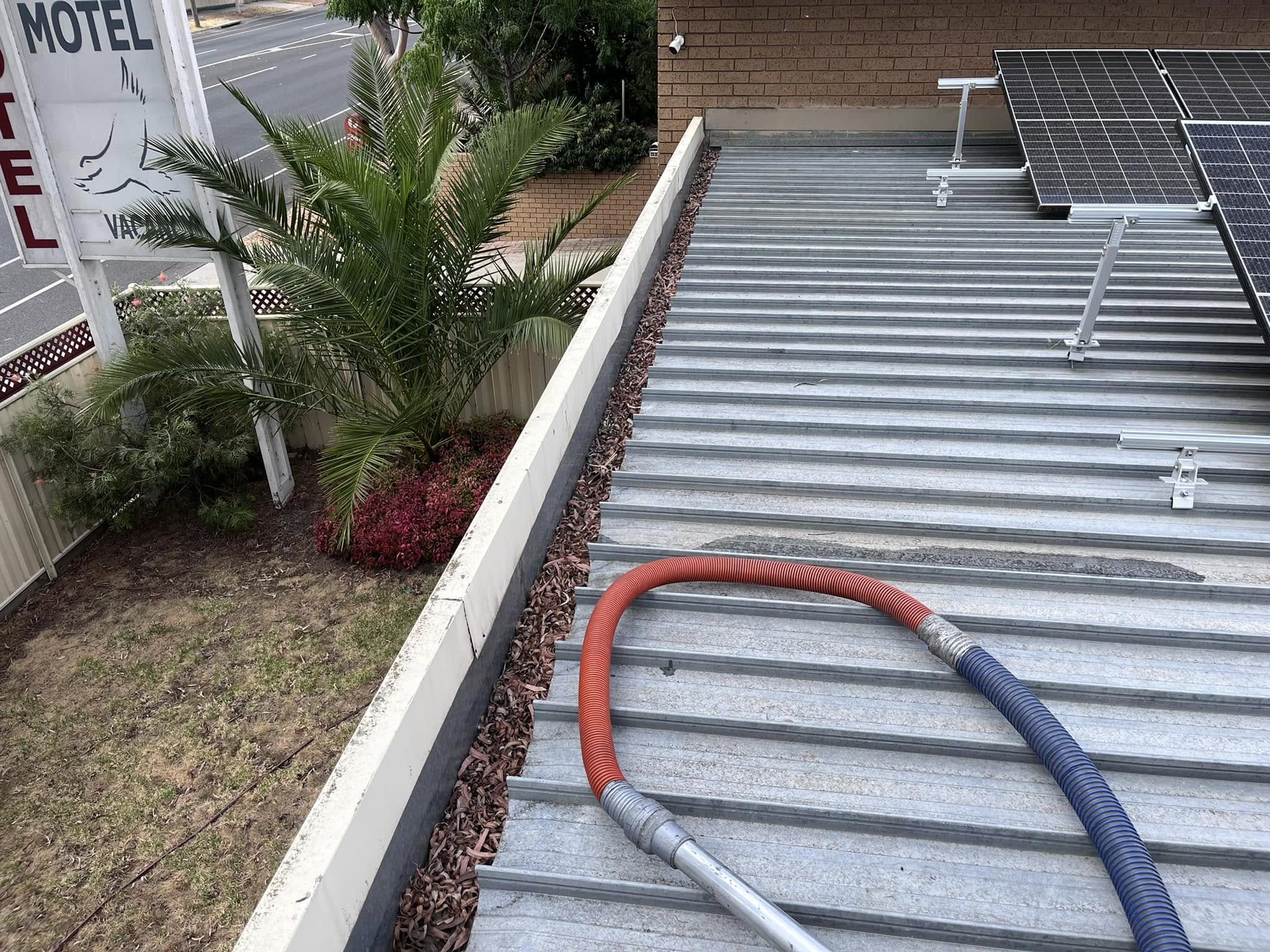 Leaves and debris built up in Marong gutter before cleaning