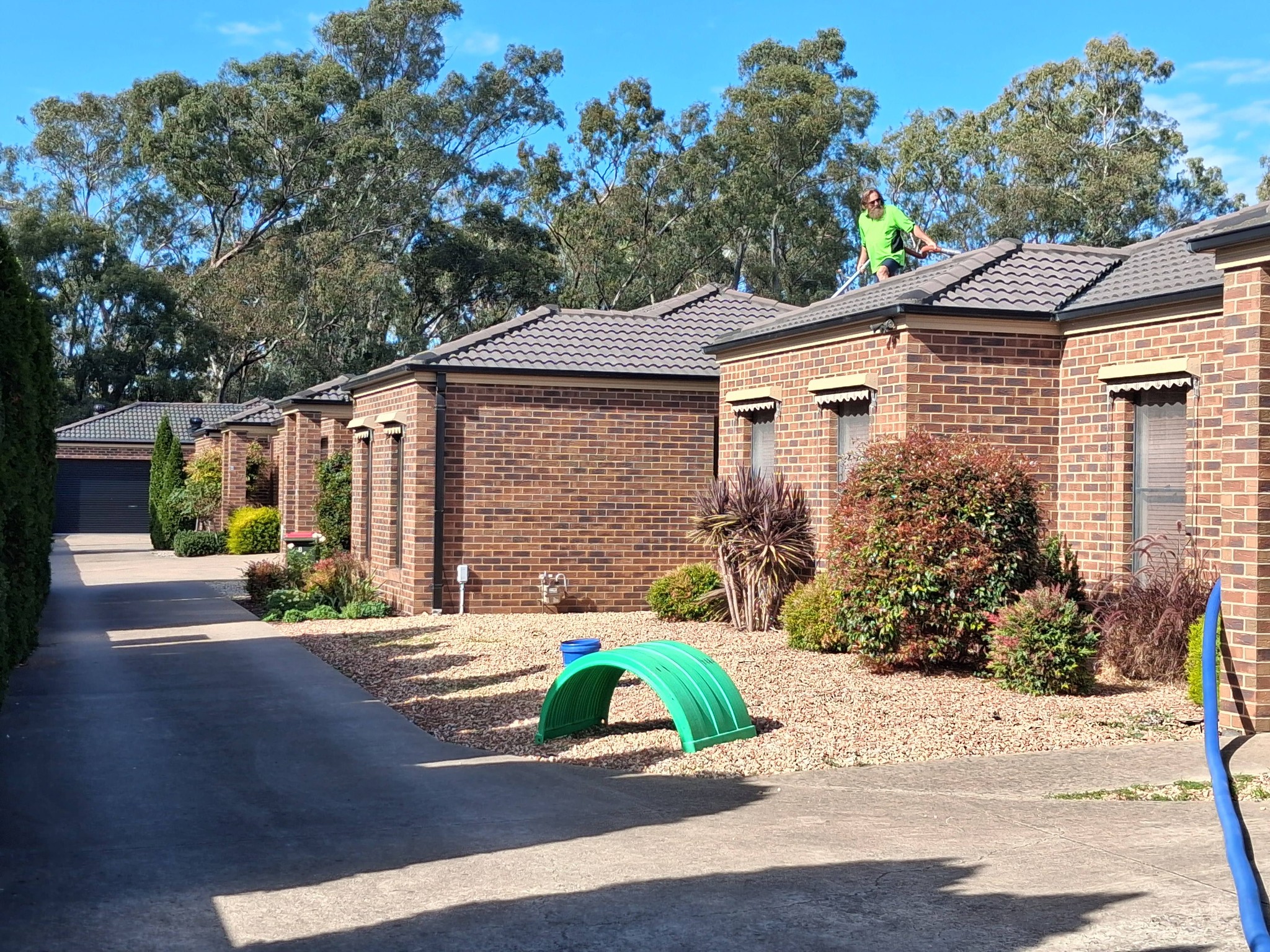 John from Gutter Muncher on the roof at Kangaroo Flat unit complex